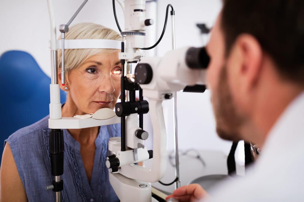 An elderly woman receiving a comprehensive eye exam.