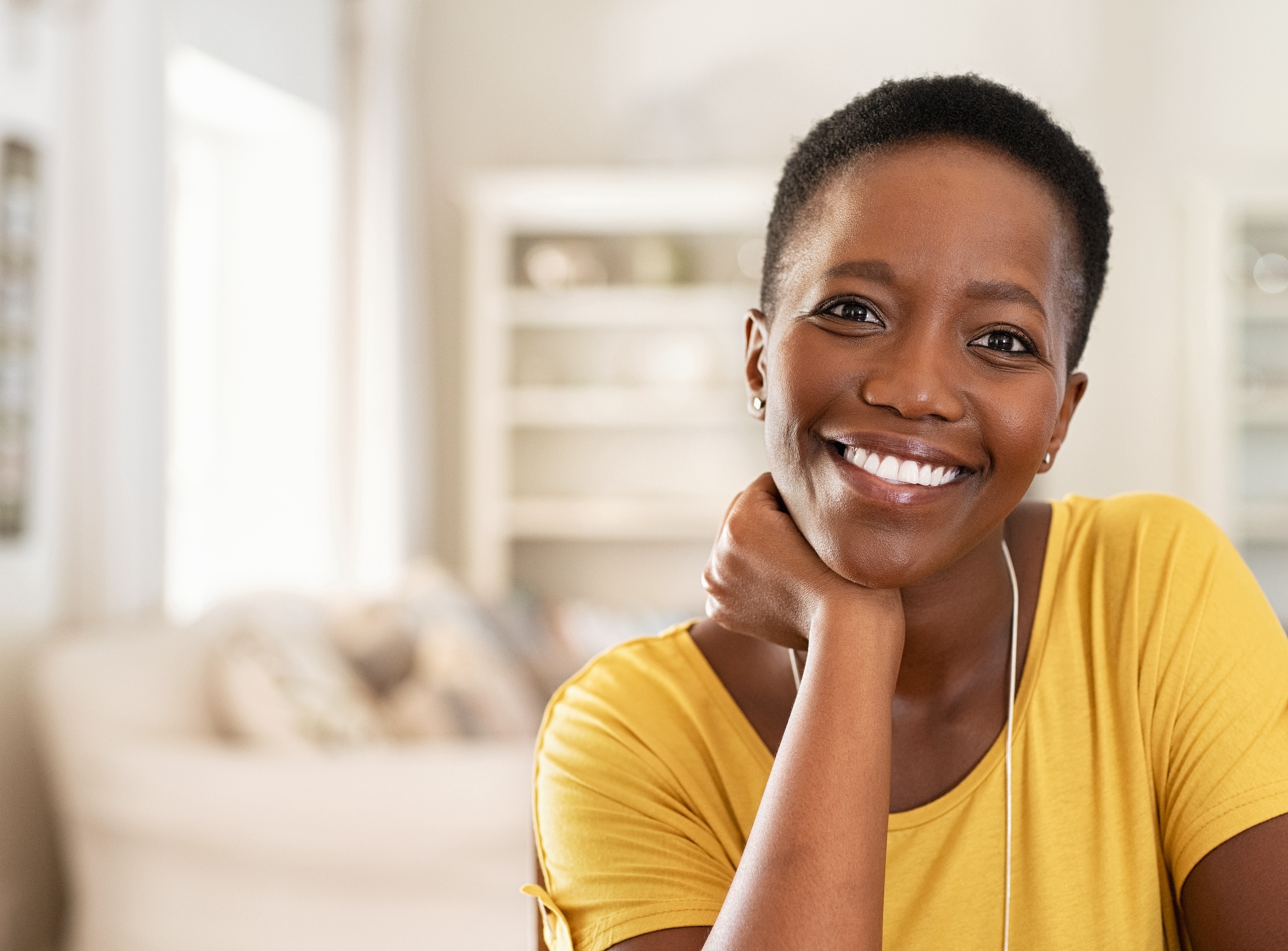 Portrait of mature woman sitting at home and looking at camera.