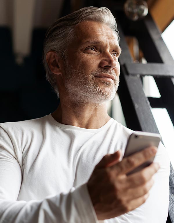 Older man holding a cell phone