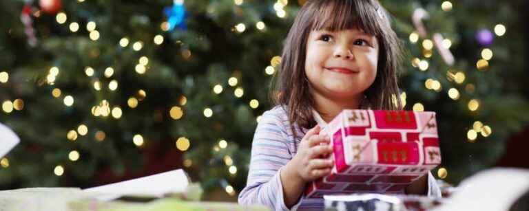 Happy child holding a Christmas Gift