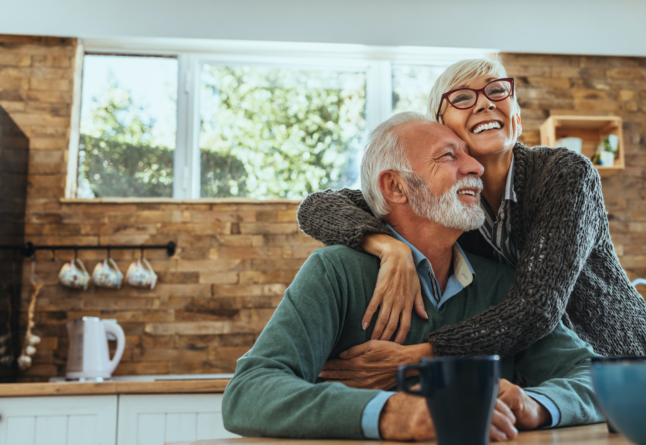 Mature woman hugging her husband