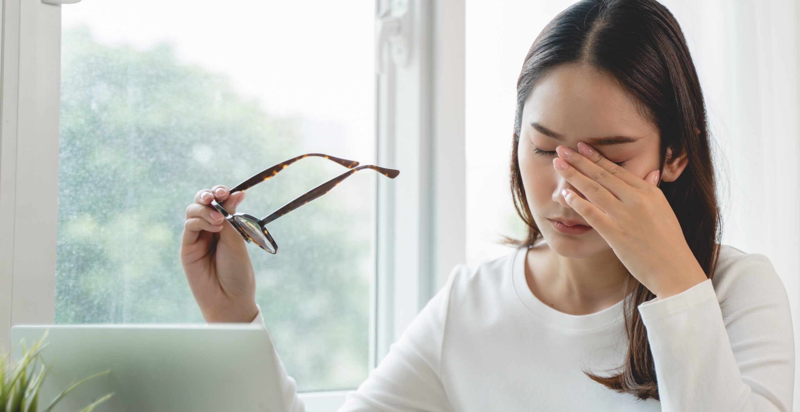 Woman rubbing her irritated dry eyes