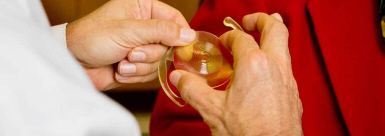 Eye doctor holding model of an enlarged Intraocular Lens