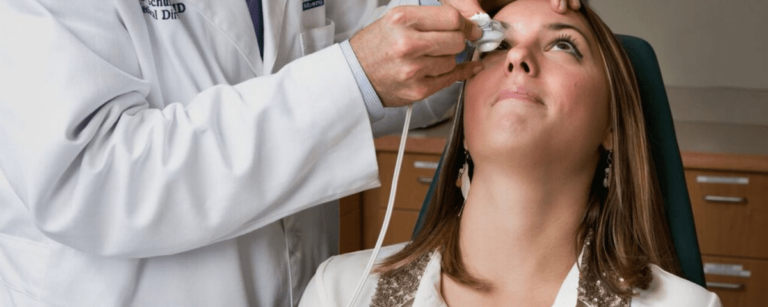 Eye doctor examining a female patient