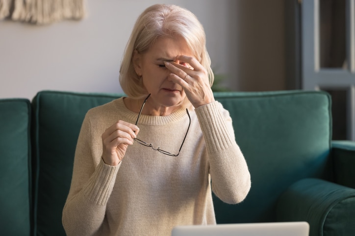 Woman rubbing her irritated eye