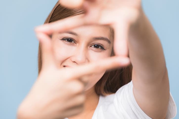 Woman making a box around her eyes