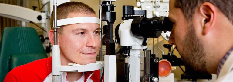 Eye doctor examining a teen patient