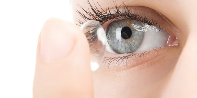 Woman putting in a contact lens